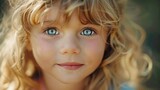 A close-up photo of a child with striking blue eyes. Ideal for family, healthcare, and advertising projects
