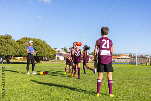 schoolchildren practising handball drills at football training photo