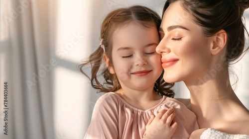 woman embracing her little daughter and smiles