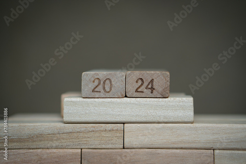 number 2024 bearing wooden blocks with gray background. Concept of a calendar year of 2024. 