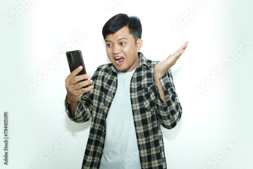 Young Asian man amazed expressions when looking his mobile phone photo