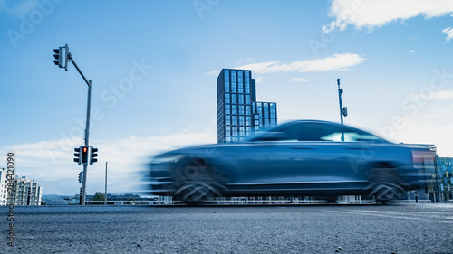 Blurred car riding down the street © Wojciech