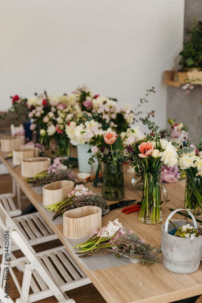 Floral arrangement workspace with fresh cut flowers. Floral arrangement workspace with fresh cut flowers.