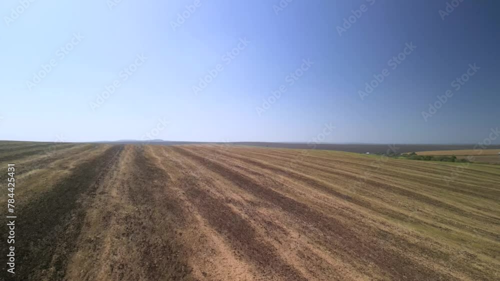 Tractor working on the field cultivating soil in Ukraine Tractor working on the field cultivating soil in Ukraine