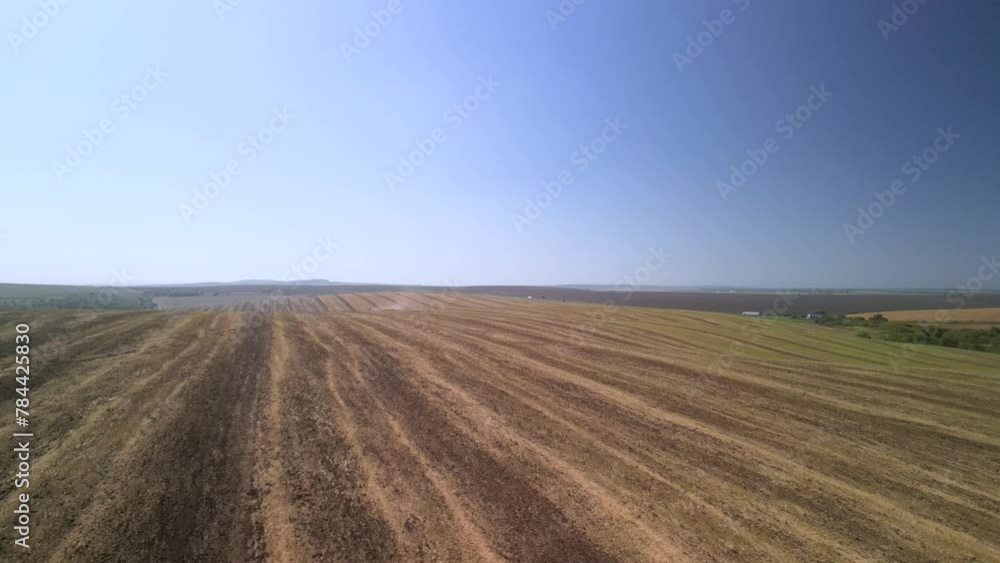 Tractor working on the field cultivating soil in Ukraine Tractor working on the field cultivating soil in Ukraine