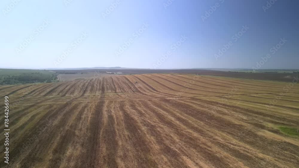 Tractor working on the field cultivating soil in Ukraine Tractor working on the field cultivating soil in Ukraine