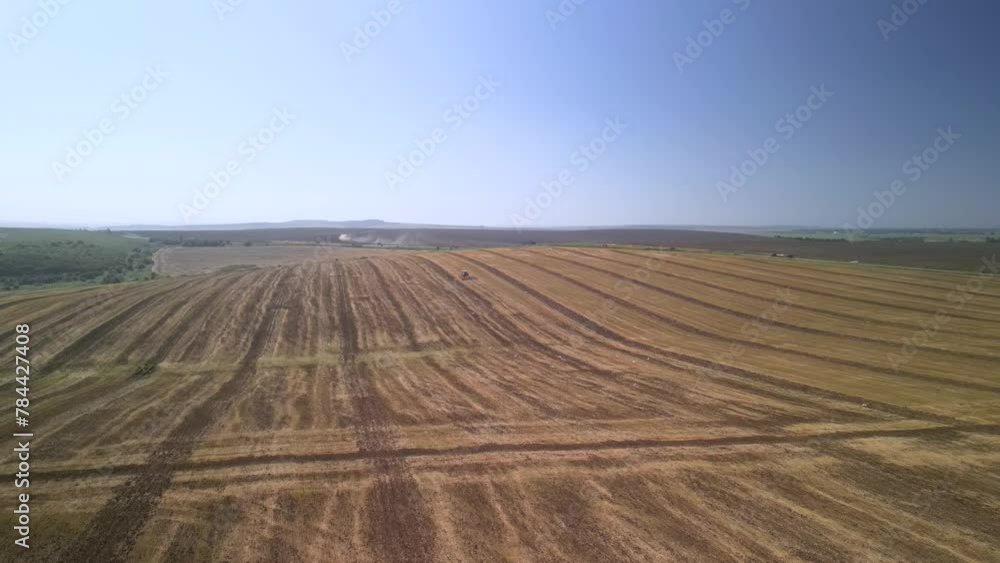Tractor working on the field cultivating soil in Ukraine Tractor working on the field cultivating soil in Ukraine