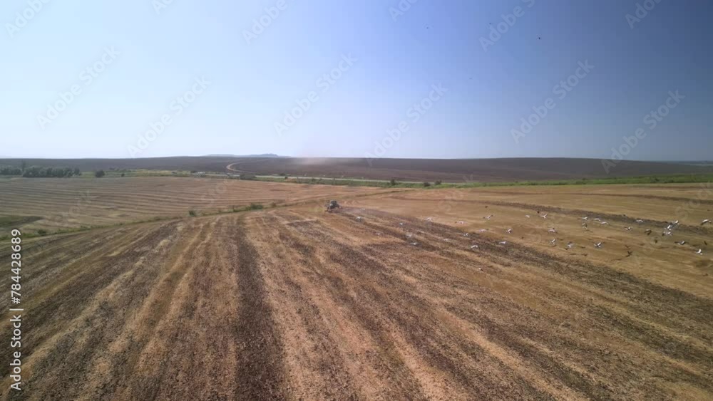 Tractor working on the field cultivating soil in Ukraine Tractor working on the field cultivating soil in Ukraine