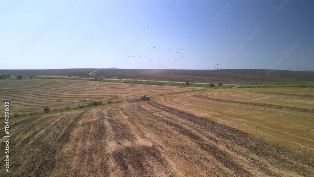 Tractor working on the field cultivating soil in Ukraine Tractor working on the field cultivating soil in Ukraine