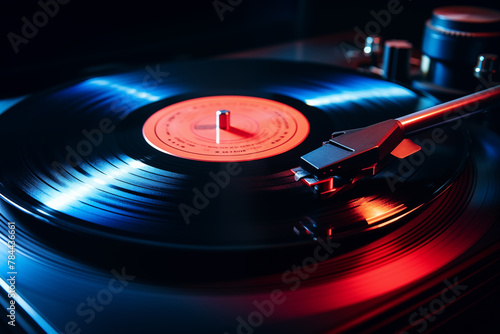 A close-up of a vinyl record player with a spinning disc, illuminated by dynamic red and blue lighting, capturing the essence of music playback.