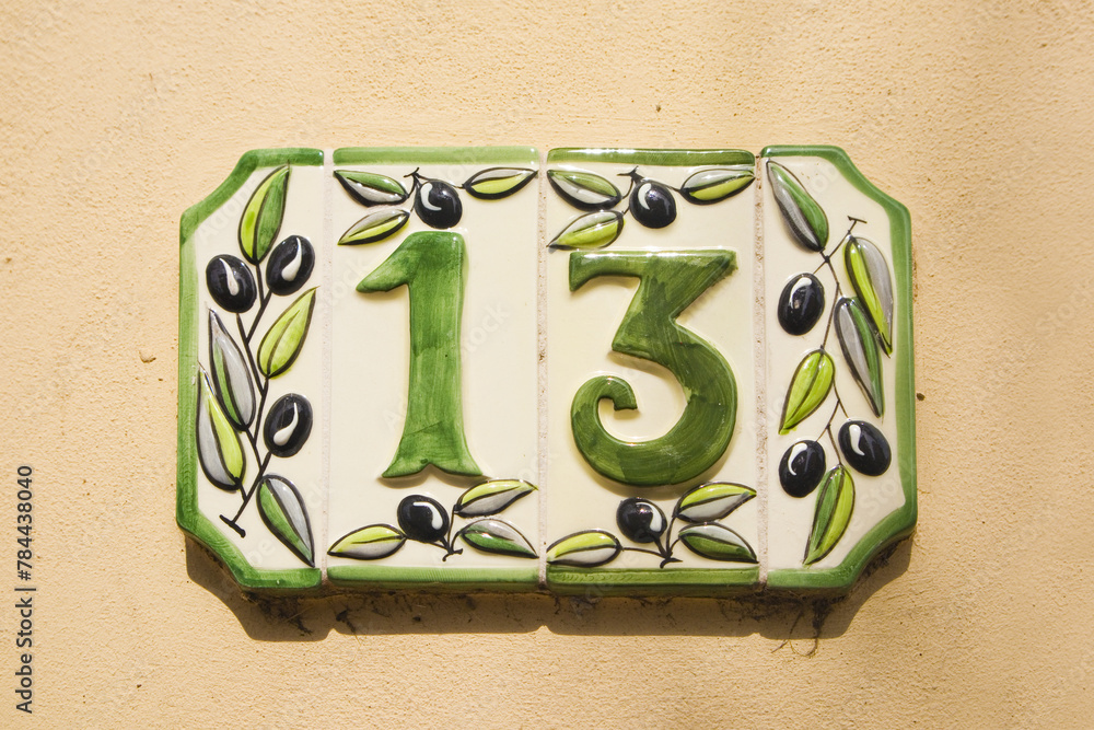 Close up view of ceramic address plate with number 13