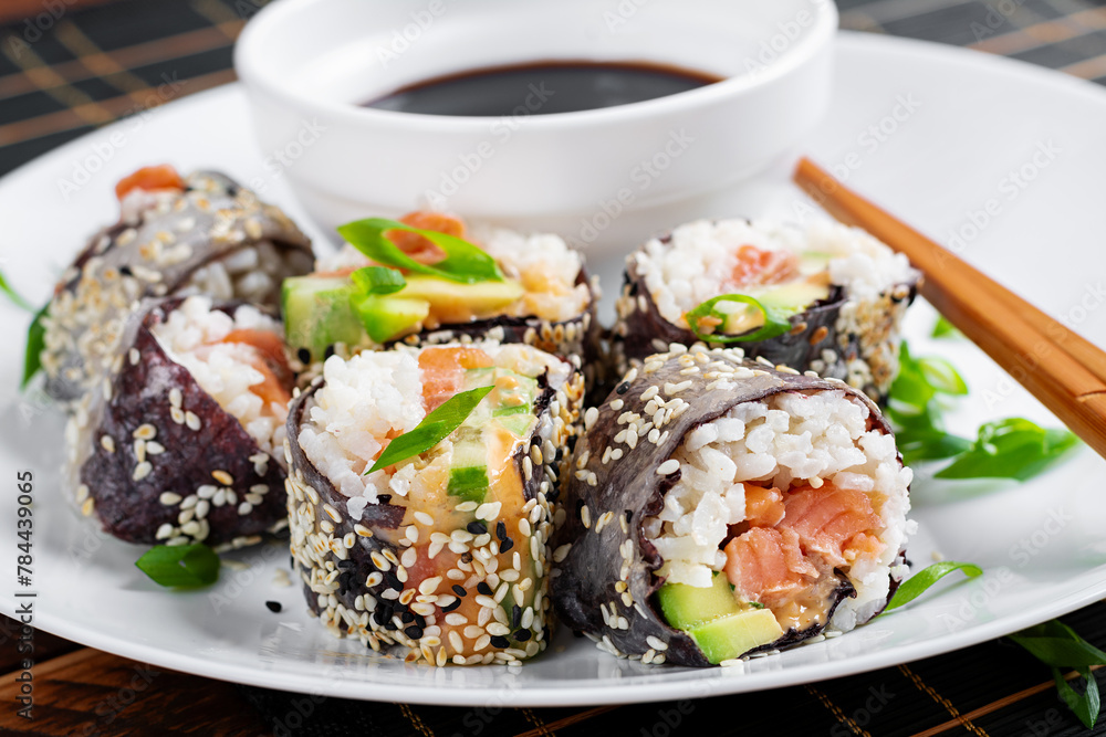 Spring roll with nori, sushi rice, salmon, cucumber and avocado, sriracha and sesame mayonnaise. Spring roll with nori, sushi rice, salmon, cucumber and avocado, sriracha and sesame mayonnaise.