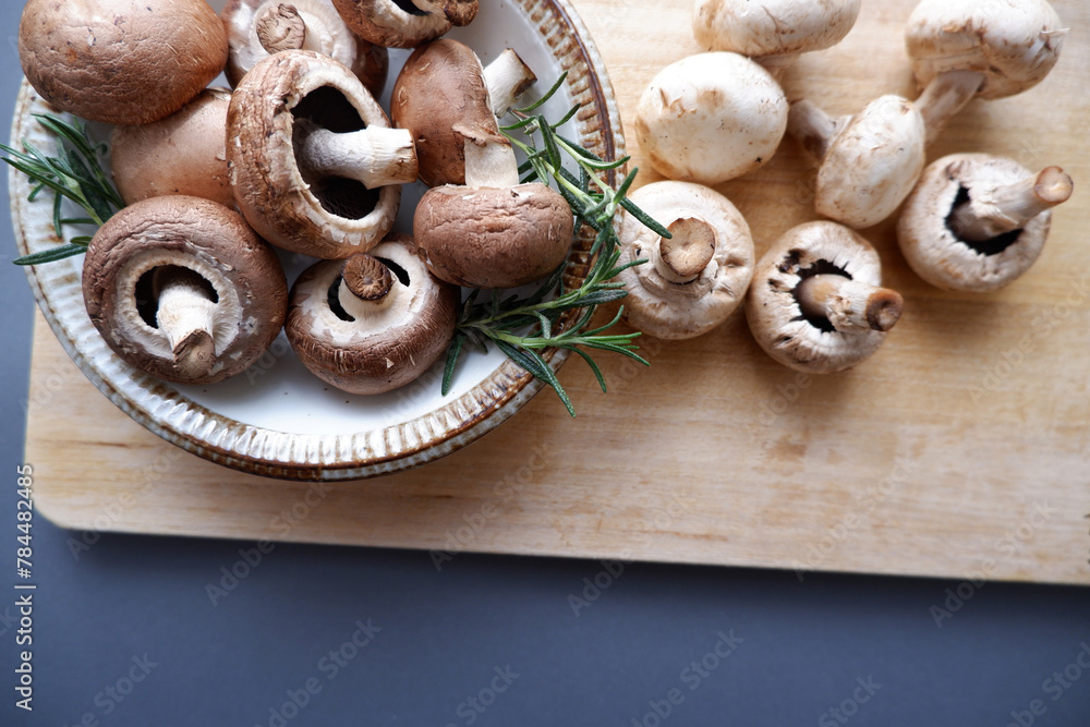 Champignon mushroom on the wooden table. healthy food concept decoration background. Mushrooms composition on wooden plate. Champignon mushroom on the wooden table. healthy food concept decoration background. Mushrooms composition on wooden plate.