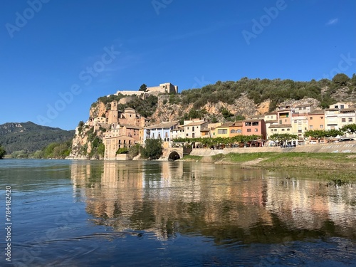 Spanish Castle of Miravet at the river Ebro with surrounding village on sunny day with bright Blue sky