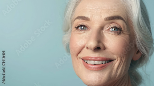 Portrait of a beautiful senior woman isolated on blue background