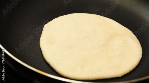 Making sourdough leavened pita-like flatbread on dry frying pan
 photo