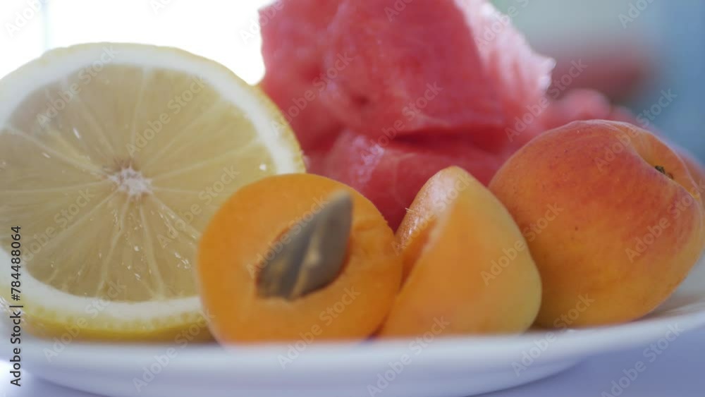 Delicious Fruit Salad with a Mix of Watermelon, Apricots, and Lemon Slices. Healthy Vegan Diet with Fruits and Vitamins. Delicious Fruit Salad with a Mix of Watermelon, Apricots, and Lemon Slices. Healthy Vegan Diet with Fruits and Vitamins.