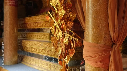 decor with golden leaves in a Buddhist temple photo