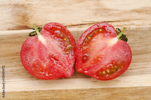 Round Pink tomato with a nose that produces heart shape when cut in half photo