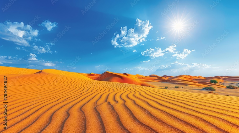 Naklejka premium sun shines over sand dunes, blue sky with wispy clouds