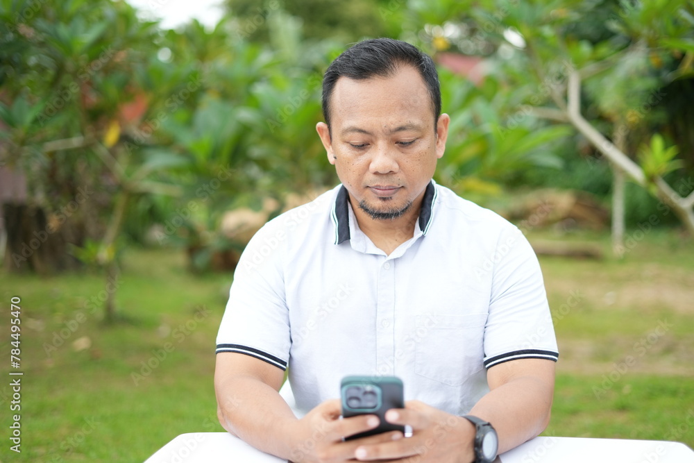The facial expression of a sitting Asian man The facial expression of a sitting Asian man