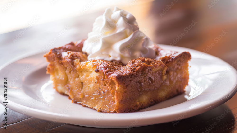 Delightful slice of argentine pastry topped with a swirl of whipped cream, served on a white plate Delightful slice of argentine pastry topped with a swirl of whipped cream, served on a white plate