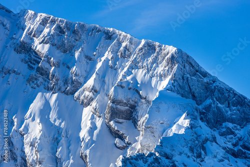 Steep mountain cliffs with snow and ice photo
