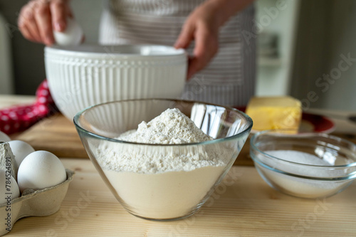 Bowl with flour on kitchen table for baking ingredient