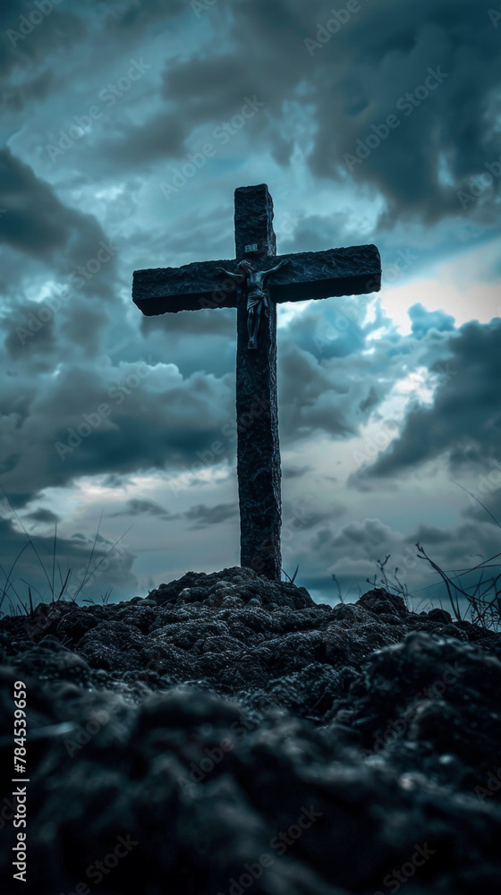 A cross is standing on a hill in the middle of a cloudy sky
