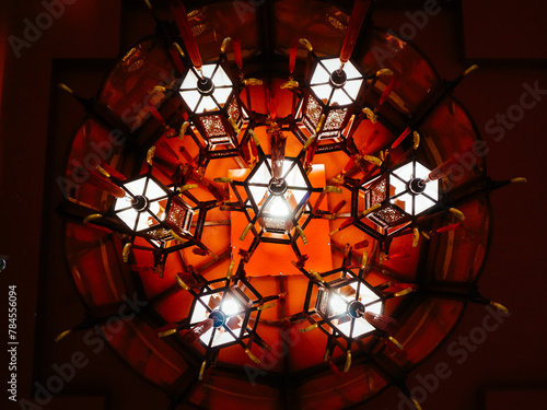Ancient red chandelier from low angle perspective in a dark background