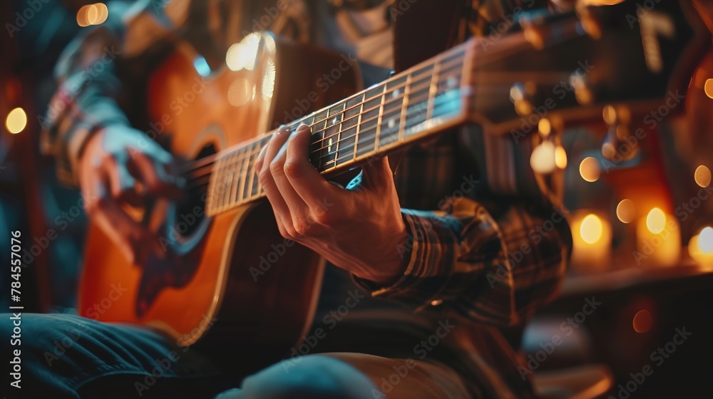 Fototapeta premium Guitarist engrossed in a melodic performance, fingers gracefully strumming over acoustic guitar strings, under cozy ambient lighting