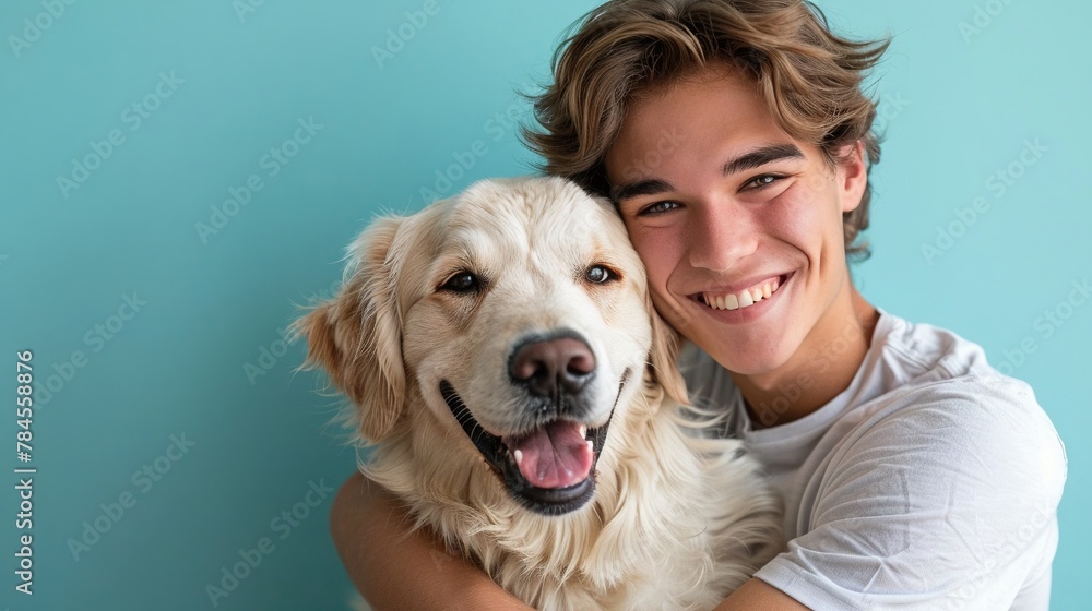 Young owner cuddling retriever, smiling, light blue studio backdrop, heartfelt moment, copy area Young owner cuddling retriever, smiling, light blue studio backdrop, heartfelt moment, copy area