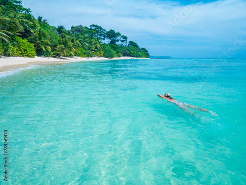 Serene tropical getaway woman relaxing in clear blue waters