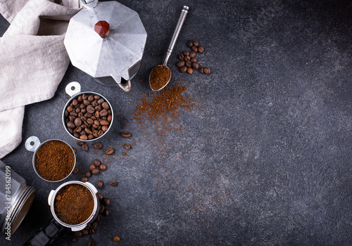 Grounded coffee, beans, coffe maker and spicces photo