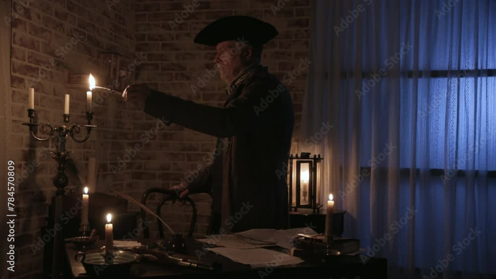 18th century man lighting candles in his home 18th century man lighting candles in his home