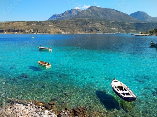 View of boats on the clear turquoise sea in Greece on a summer day photo