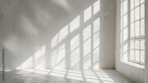 A bare window frame letting in a flood of natural light  casting geometric patterns on an otherwise empty floor  a celebration of light and space.