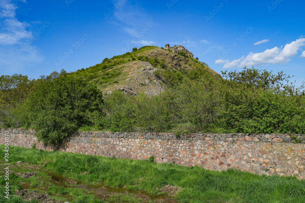 A view of Soimos Fortress with a blue sky in the background, built in 1278 on Mures Valley, Arad county, Romania A view of Soimos Fortress with a blue sky in the background, built in 1278 on Mures Valley, Arad county, Romania