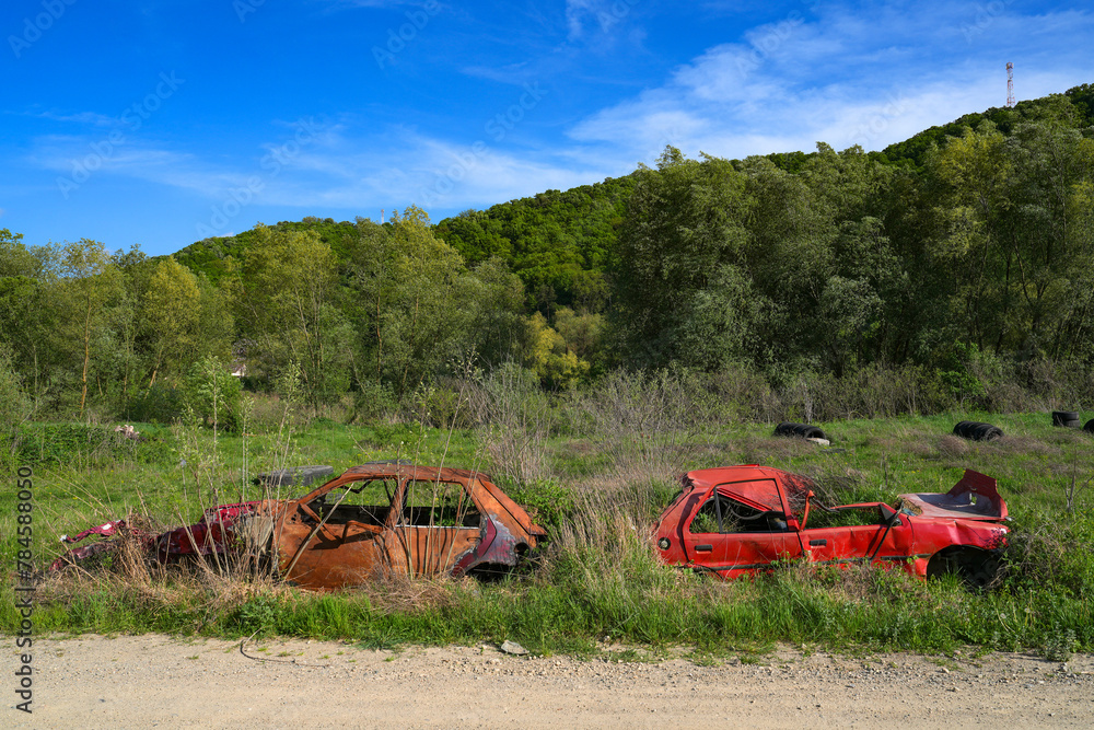 Rusty and broken red abandoned car in the outdoors. Old abandoned rusty ...