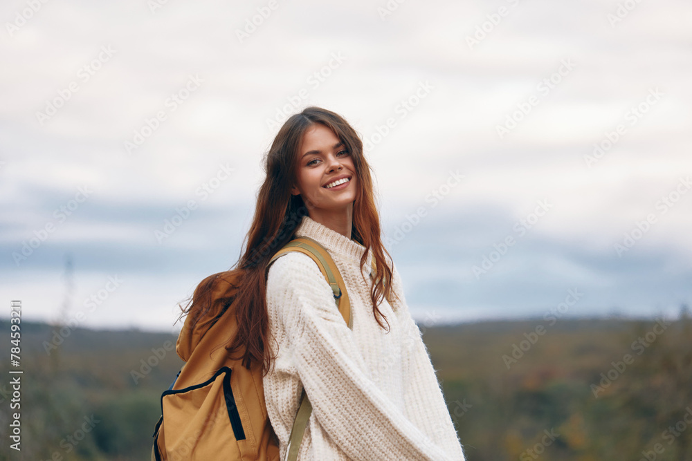 Mountain Adventure: A Smiling Woman Hiking on a Cliff in Springtime Mountain Adventure: A Smiling Woman Hiking on a Cliff in Springtime