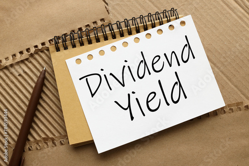 DIVIDEND YIELD craft notebook on a craft background. text on white page