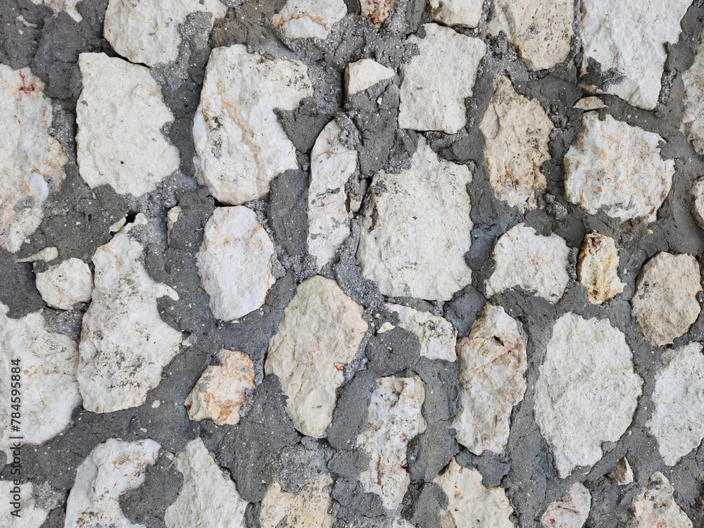 Fototapeta premium Texture of a limestone wall built against sea waves in the Eastern Mediterranean