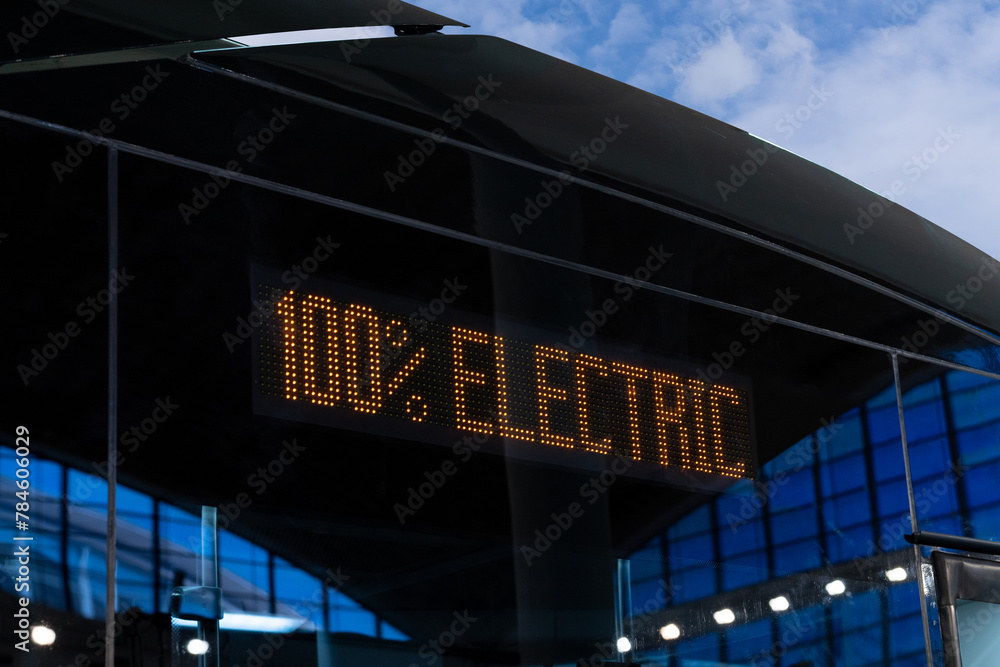 Fototapeta premium Electric bus sighboard close up. Inscription 100 percent electric.