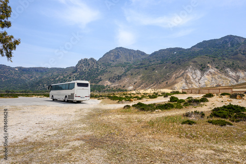A tour bus on the road near the Stefanos crater on Nisyros island. Greece