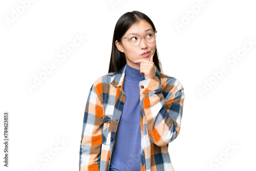 Young Asian woman over isolated chroma key background having doubts and with confuse face expression © luismolinero