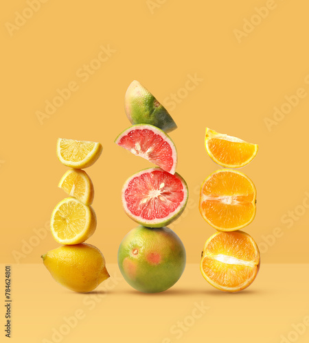 Creative layout made of grapefruit, orange fruit and lemon on the yellow background. Food concept. Macro concept. (ID: 784624801)