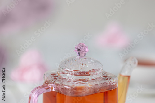 Close-up of glass teapot with beautiful pink details