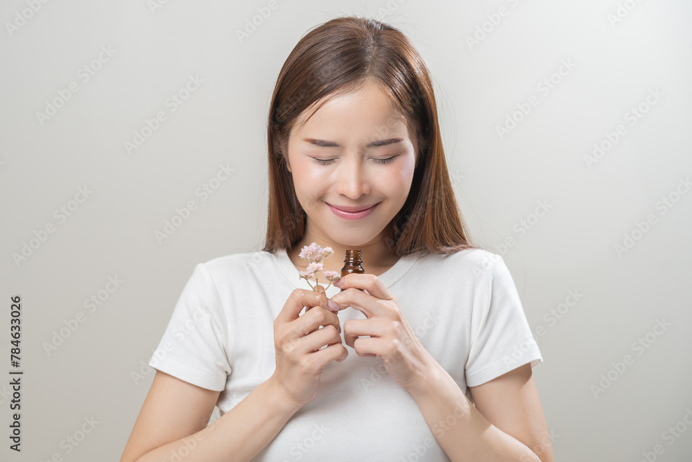 Aromatherapy, pretty asian young woman close her eyes enjoying smell fragrance of herbal from medicine natural organic essential perfume oil.Therapy treatment, beauty skin care isolated on background Aromatherapy, pretty asian young woman close her eyes enjoying smell fragrance of herbal from medicine natural organic essential perfume oil.Therapy treatment, beauty skin care isolated on background
