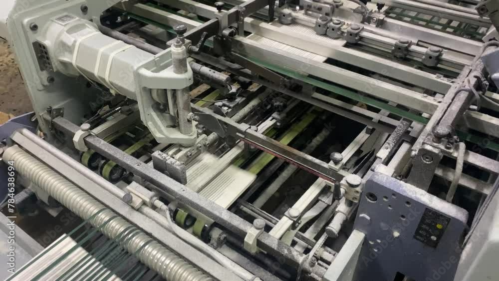 Book, magazine, production line into press plant house. Automatic assembly line, selective focus and copy space Book, magazine, production line into press plant house. Automatic assembly line, selective focus and copy space