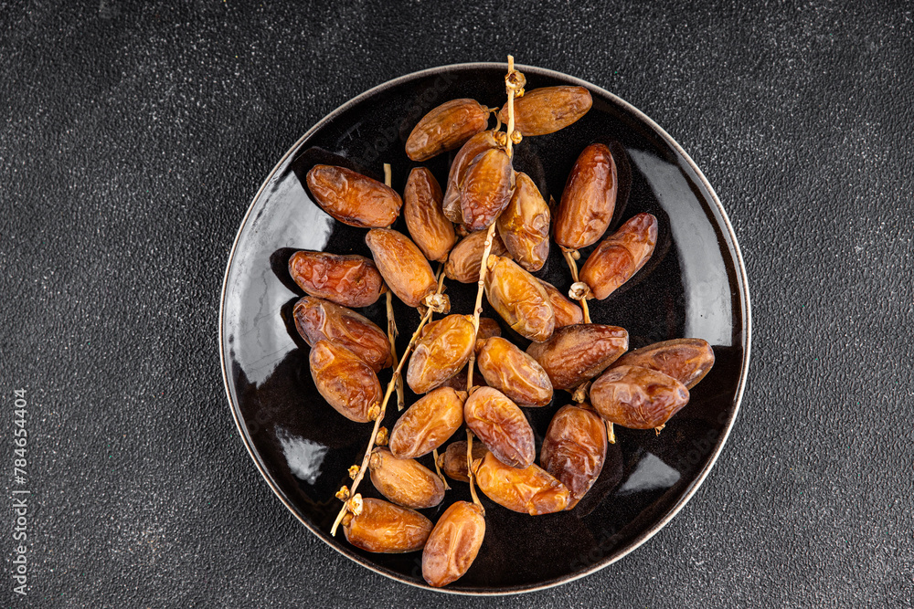 Fototapeta premium date on a branch dried sweet fruit fresh appetizer meal food snack on the table copy space food background rustic top view